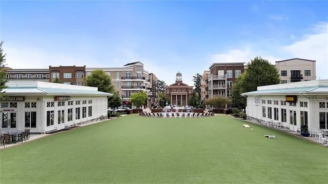 a view of a house with a big yard and large trees