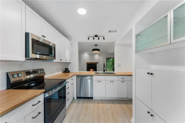 a kitchen with a sink stove and microwave