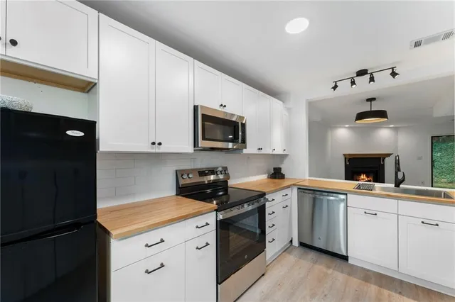 a kitchen with a sink a stove and cabinets