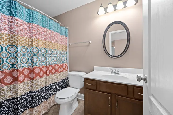 a bathroom with a sink mirror vanity and toilet