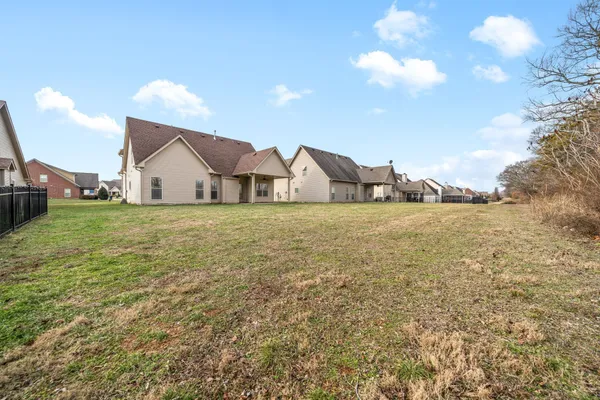 a view of a house with a yard and sitting area