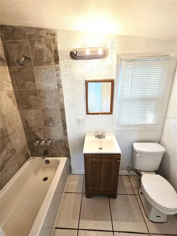 a view of a room with a large window with wooden floor