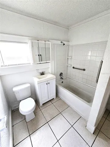 a bathroom with a sink a toilet a mirror and a bathtub