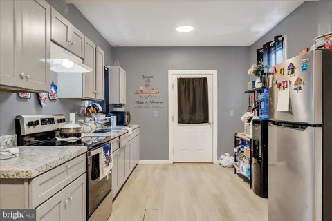a kitchen with a refrigerator and a sink