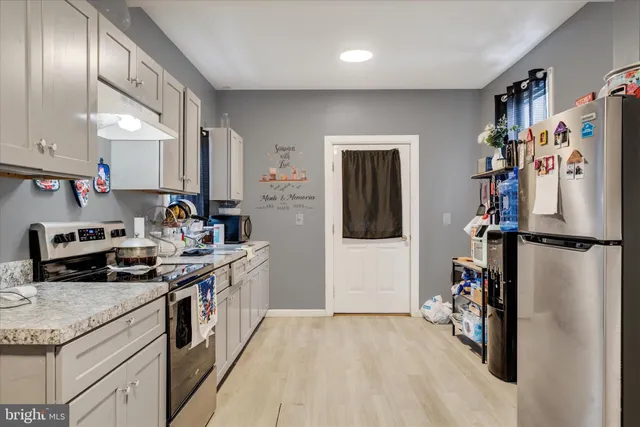 a kitchen with a refrigerator and a sink