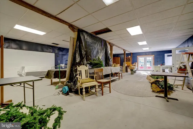 a living room with lots of furniture and a potted plant