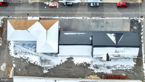 a room with water heater and wooden walls