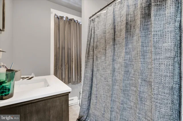 a bathroom with a sink a vanity and a shower