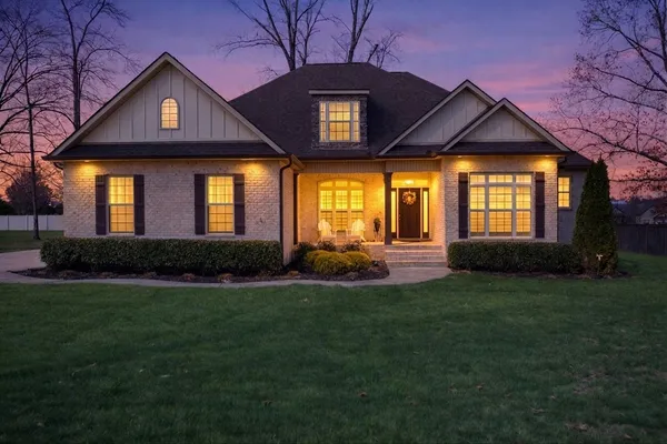 a front view of a house with a yard and garage