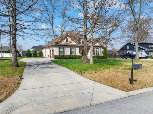 a front view of a house with a garden
