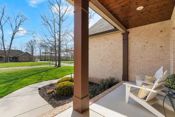 a kitchen with stainless steel appliances granite countertop a table chairs stove and refrigerator