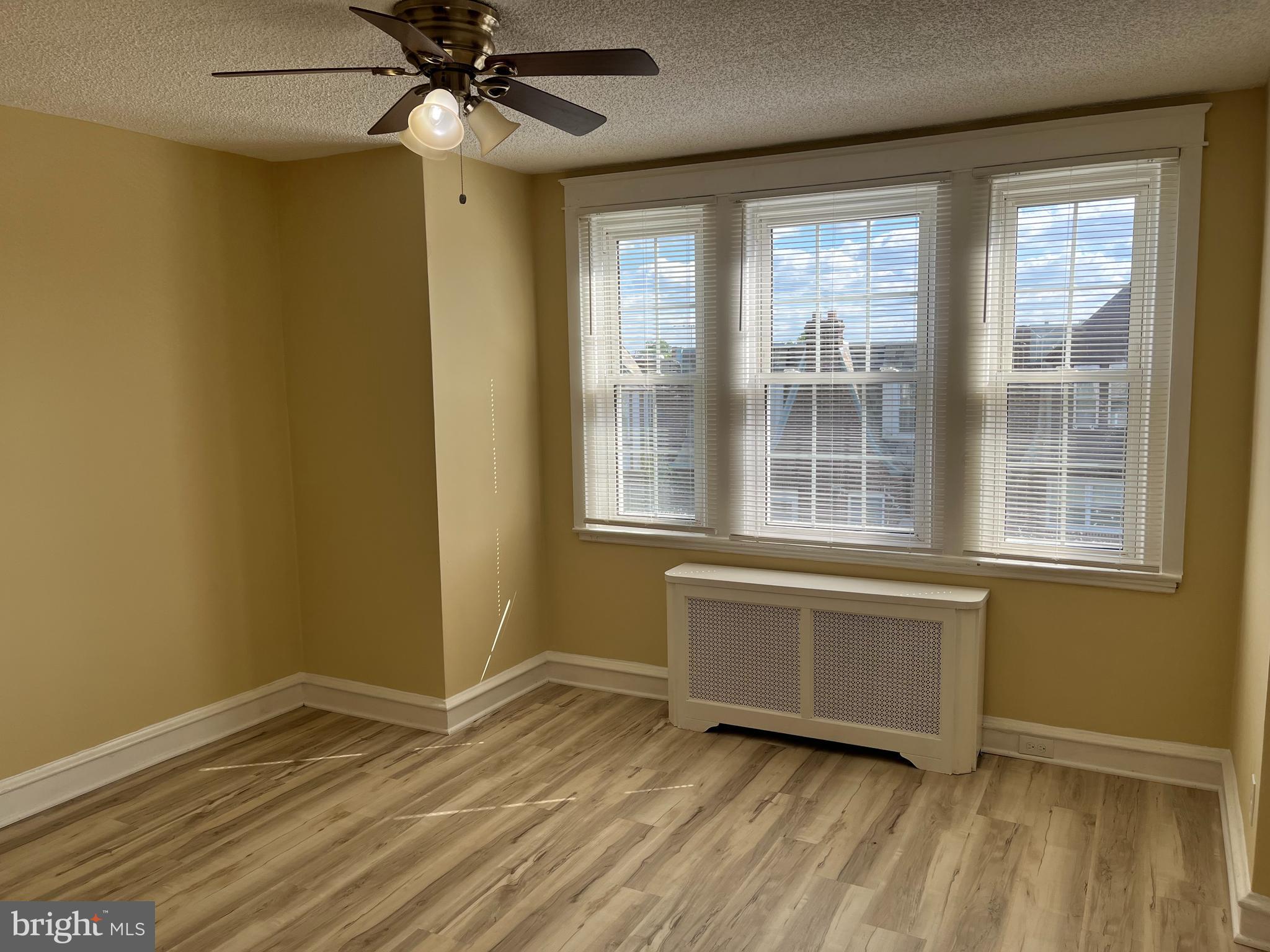 1323 Gilham Street Philadelphia, PA 19111 - Photo 12 of 35 an empty room with wooden floor fan and windows