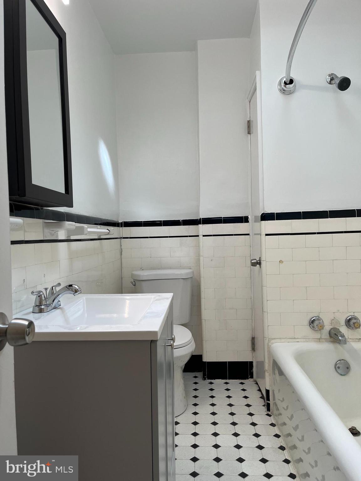 1323 Gilham Street Philadelphia, PA 19111 - Photo 17 of 35 a bathroom with a sink a mirror and a bathtub