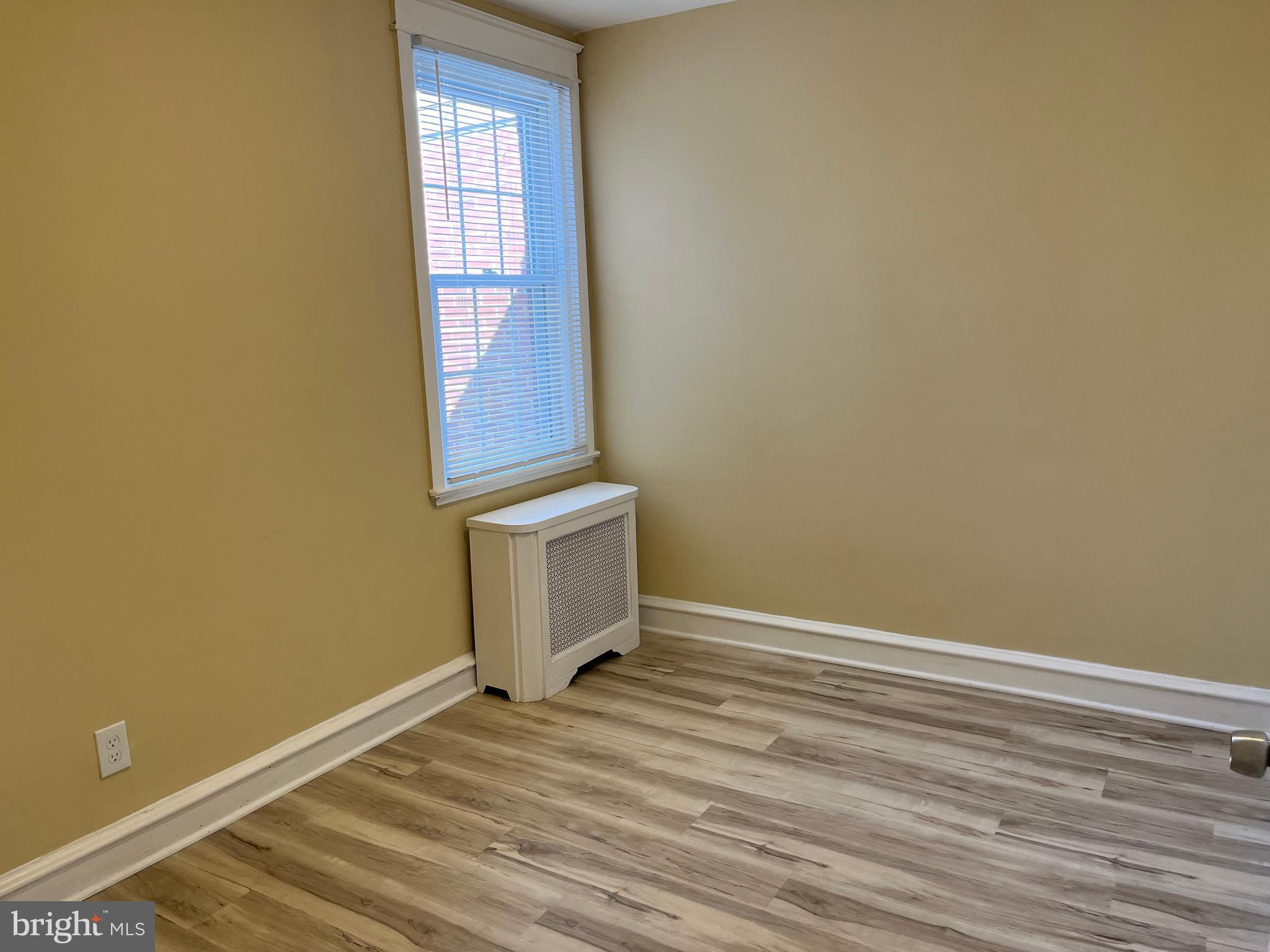 1323 Gilham Street Philadelphia, PA 19111 - Photo 23 of 35 a view of an empty room with wooden floor and a window