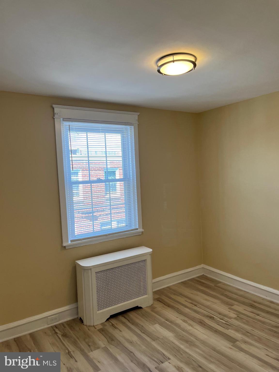 1323 Gilham Street Philadelphia, PA 19111 - Photo 24 of 35 a view of an empty room with wooden floor and a window