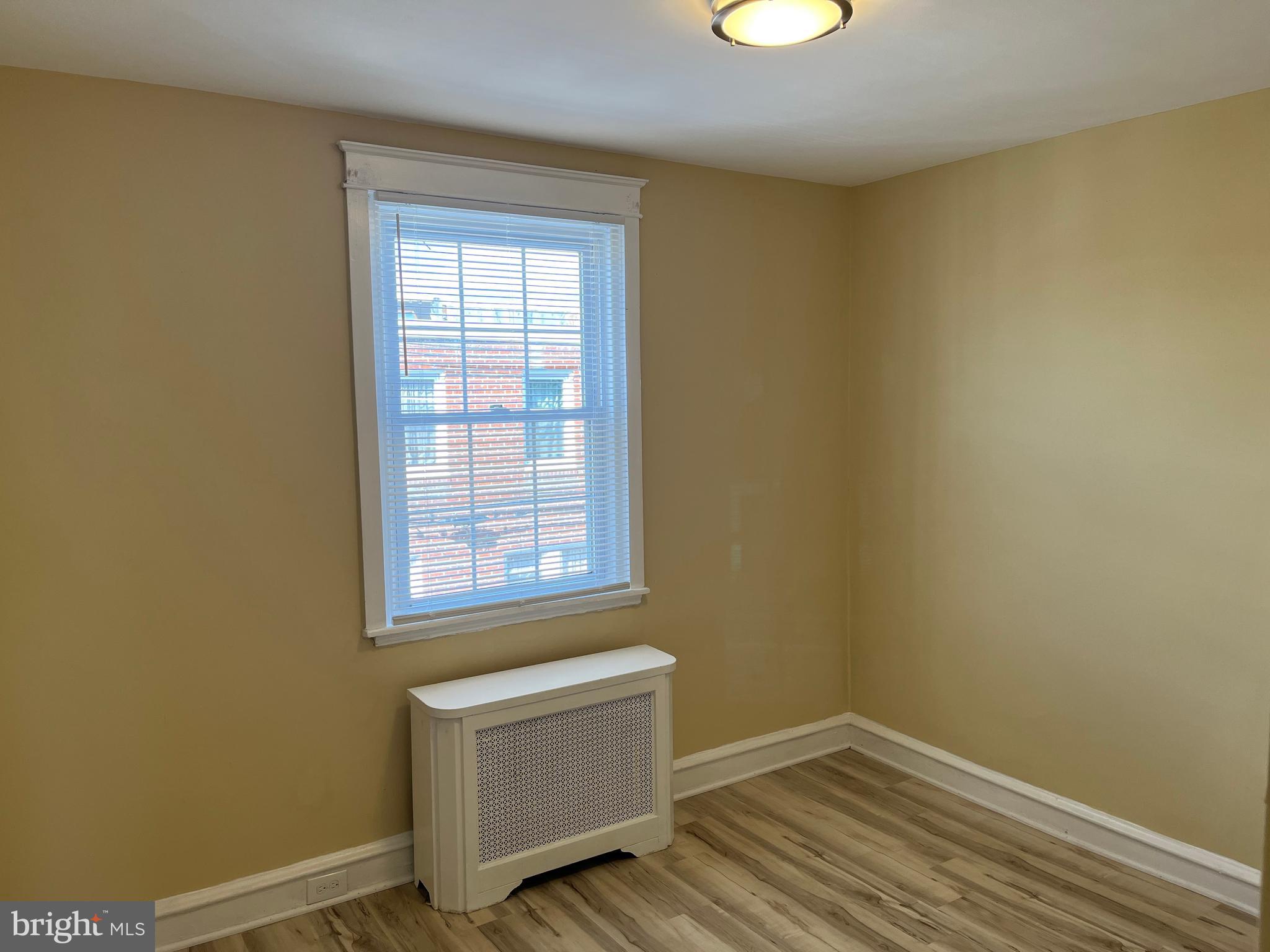 1323 Gilham Street Philadelphia, PA 19111 - Photo 25 of 35 an empty room with wooden floor and windows