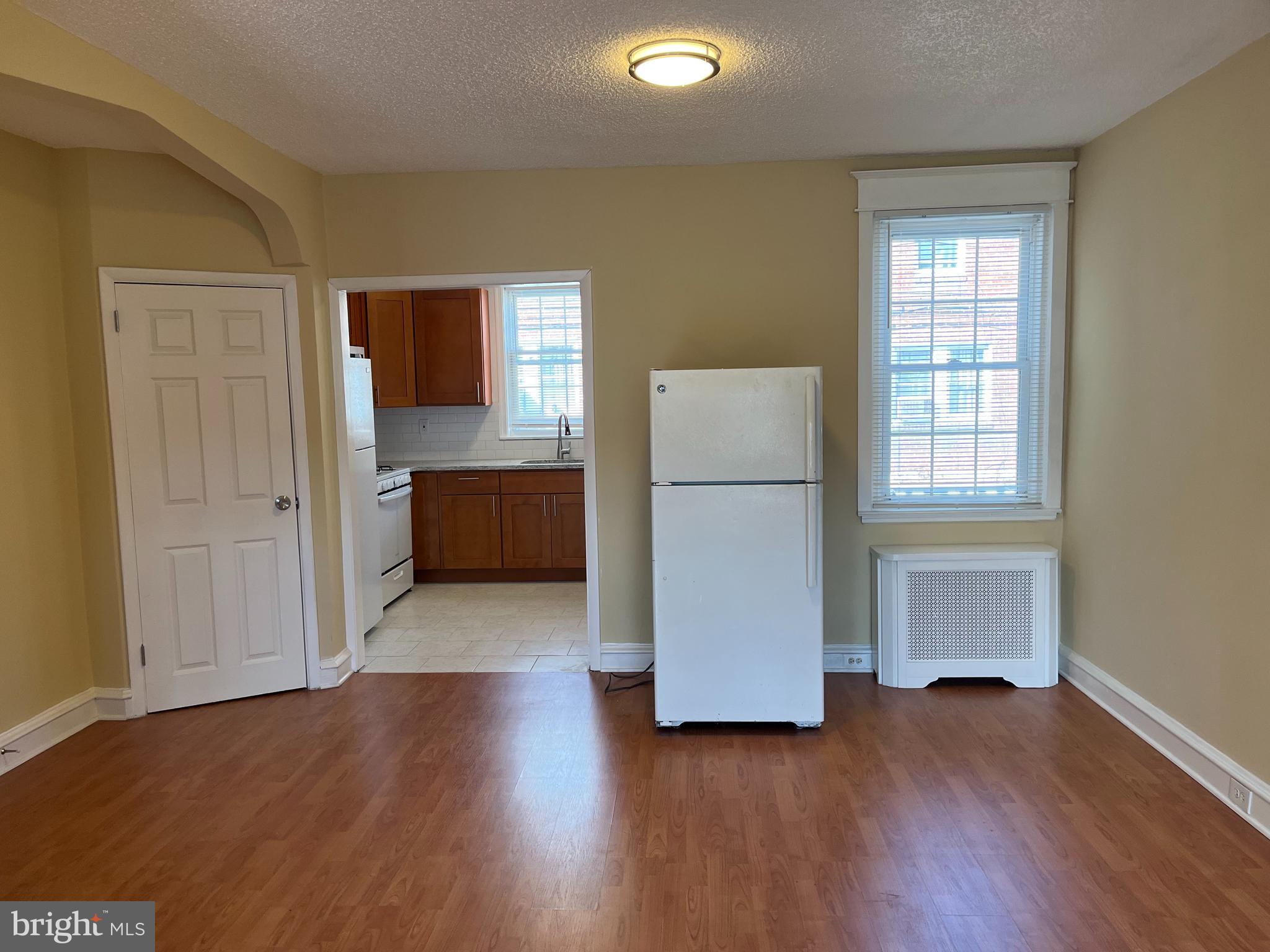 1323 Gilham Street Philadelphia, PA 19111 - Photo 6 of 35 a view of kitchen and utility room with wooden floor