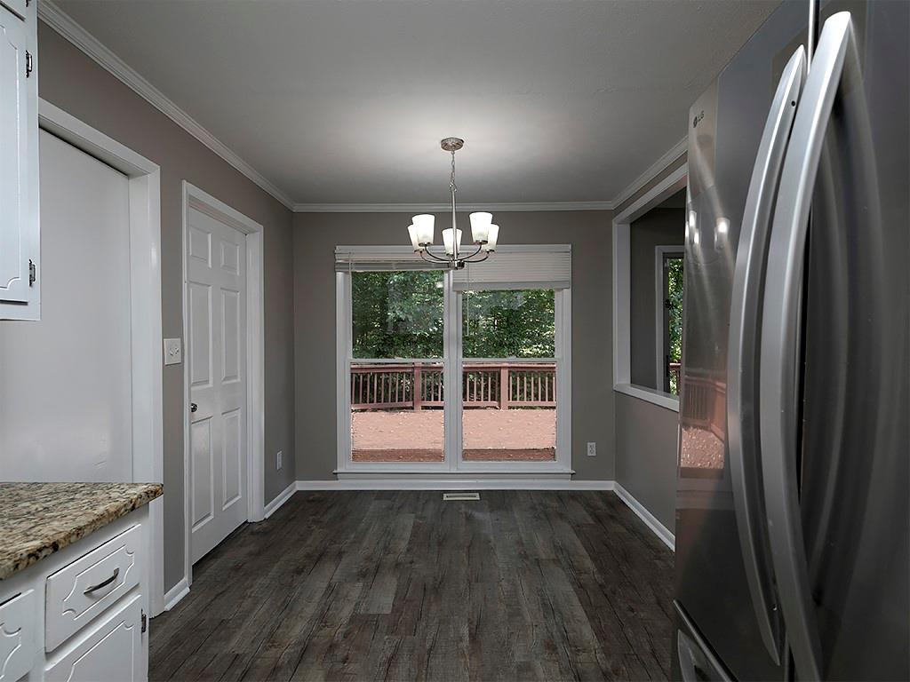 581 Autumn Lane Marietta, GA 30068 - Photo 11 of 28 a view of an empty room with wooden floor and a window
