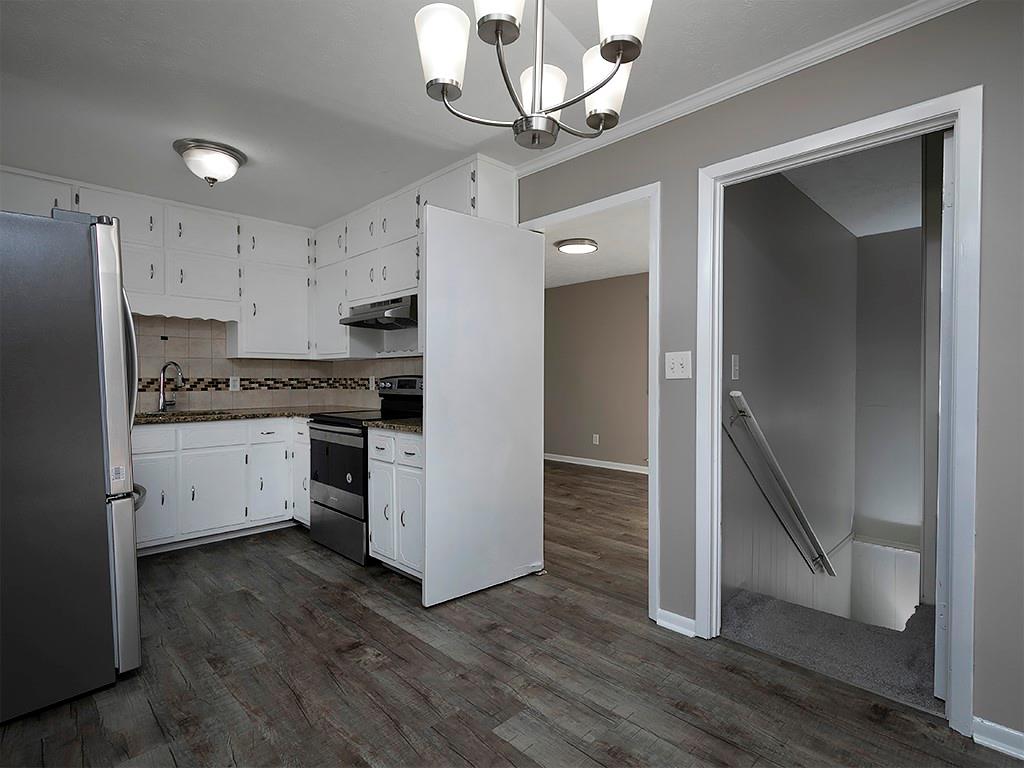 581 Autumn Lane Marietta, GA 30068 - Photo 13 of 28 a kitchen with a refrigerator and a stove top oven