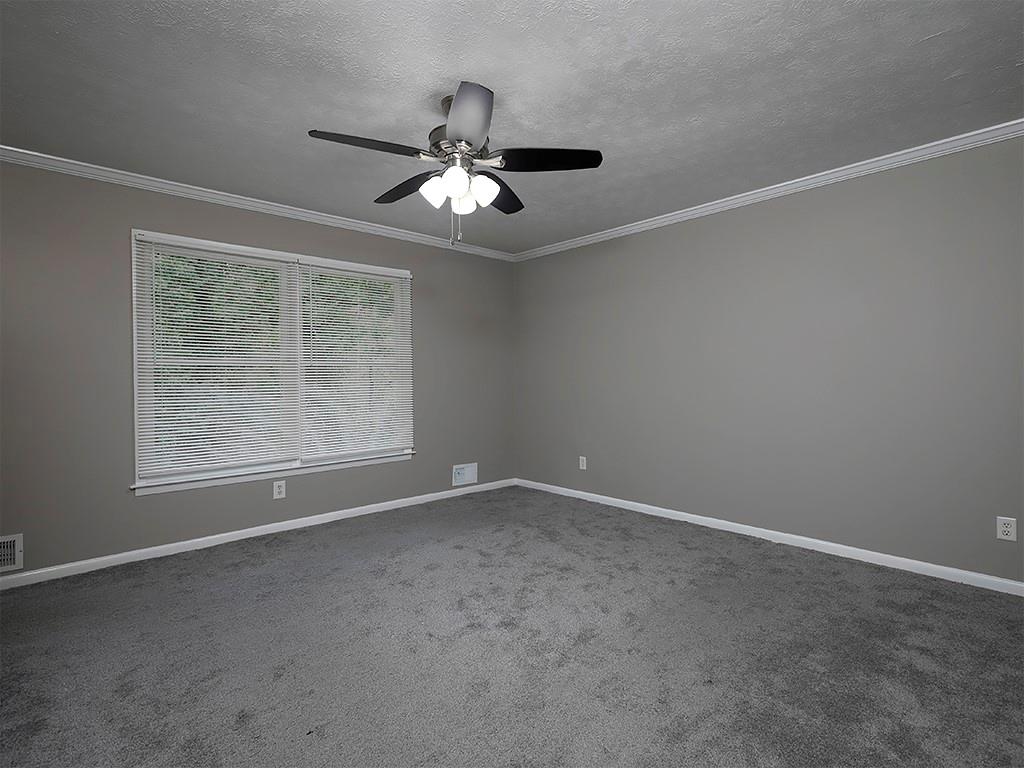 581 Autumn Lane Marietta, GA 30068 - Photo 16 of 28 an empty room with windows and fan