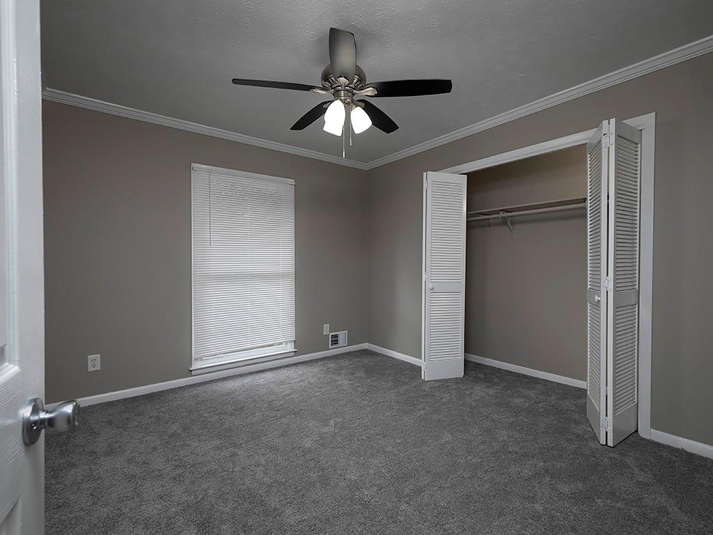 581 Autumn Lane Marietta, GA 30068 - Photo 21 of 28 an empty room with closet and a ceiling fan