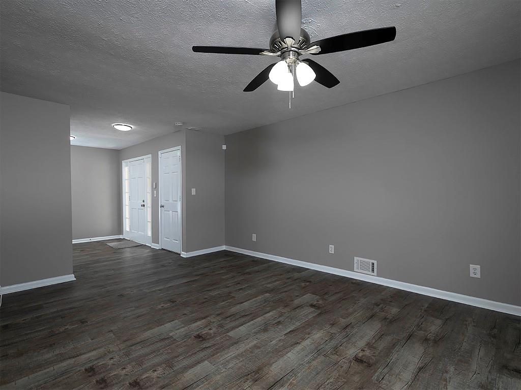 581 Autumn Lane Marietta, GA 30068 - Photo 7 of 28 an empty room with wooden floor fan and window