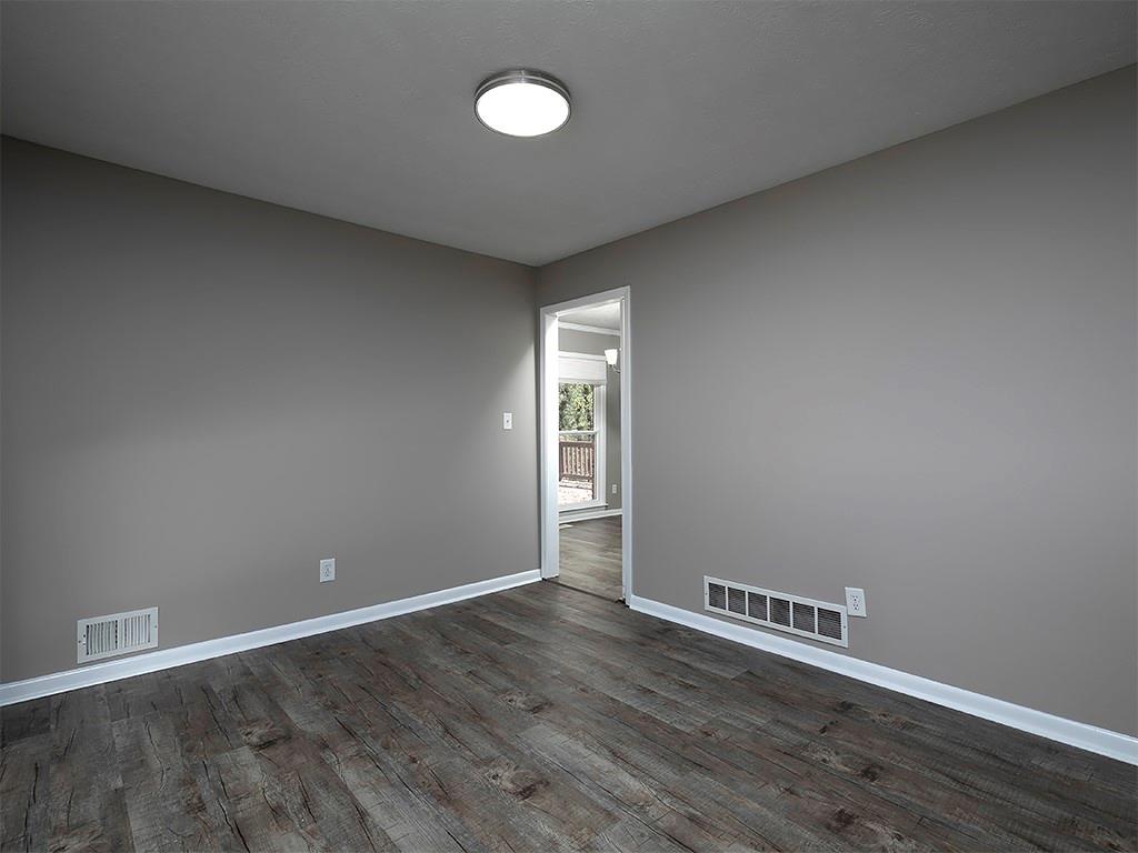 581 Autumn Lane Marietta, GA 30068 - Photo 8 of 28 a view of an empty room with wooden floor and a window