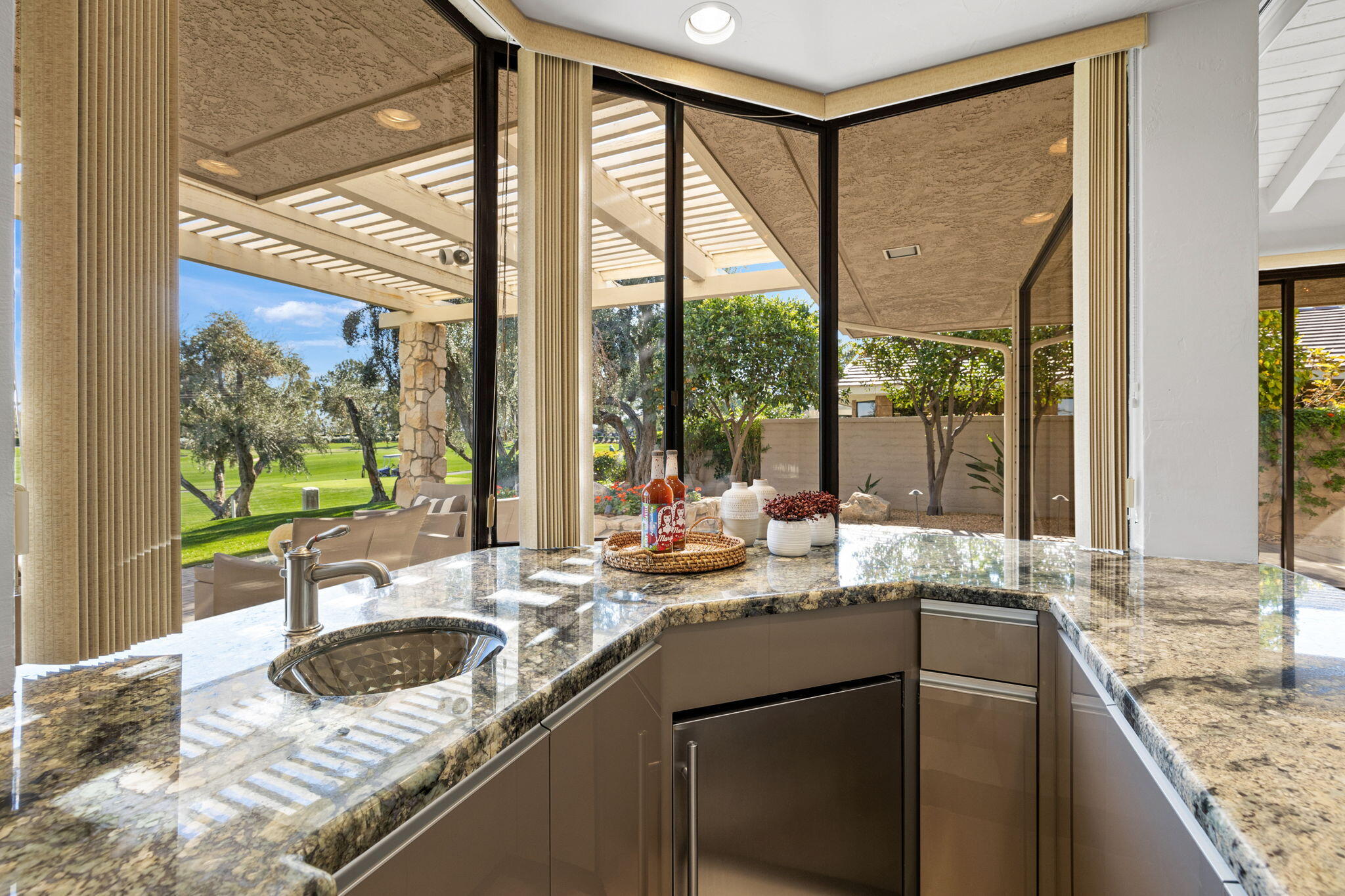 95 Mayfair Drive Rancho Mirage, CA 92270 - Photo 20 of 74 a kitchen with granite countertop a sink and a large window