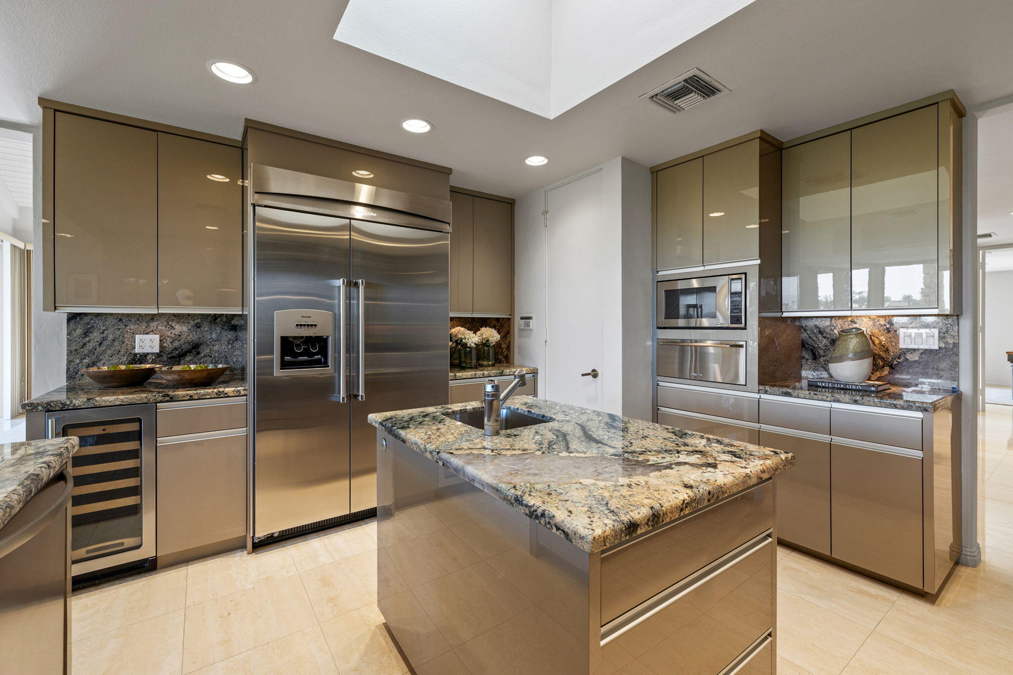 95 Mayfair Drive Rancho Mirage, CA 92270 - Photo 30 of 74 a kitchen with stainless steel appliances granite countertop a sink and a refrigerator