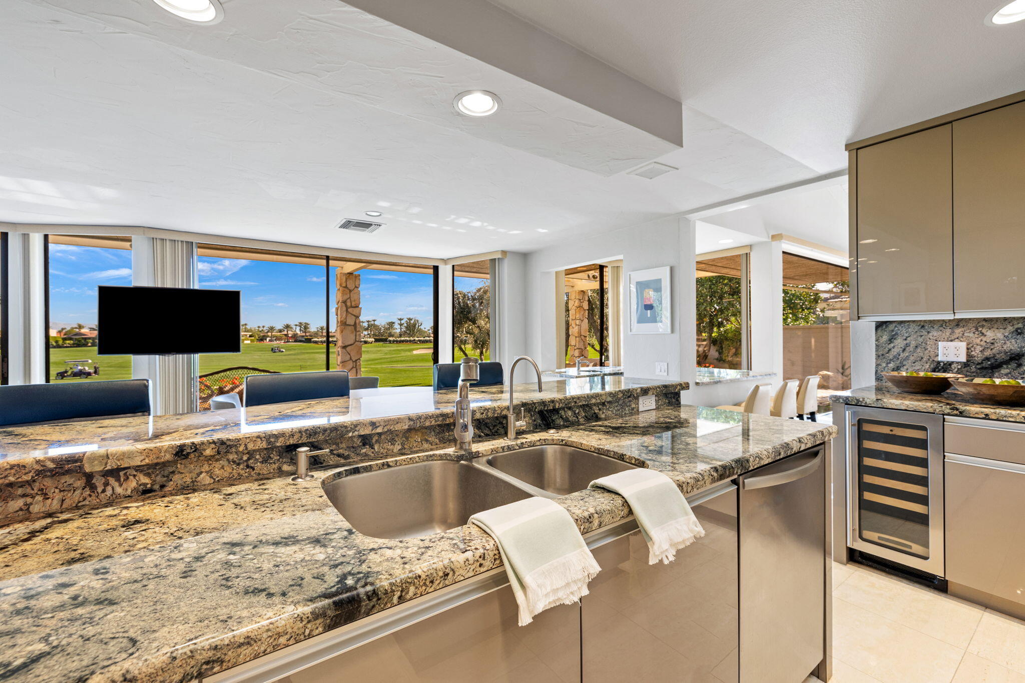 95 Mayfair Drive Rancho Mirage, CA 92270 - Photo 31 of 74 a view of a kitchen with kitchen island granite countertop a sink and a counter top space