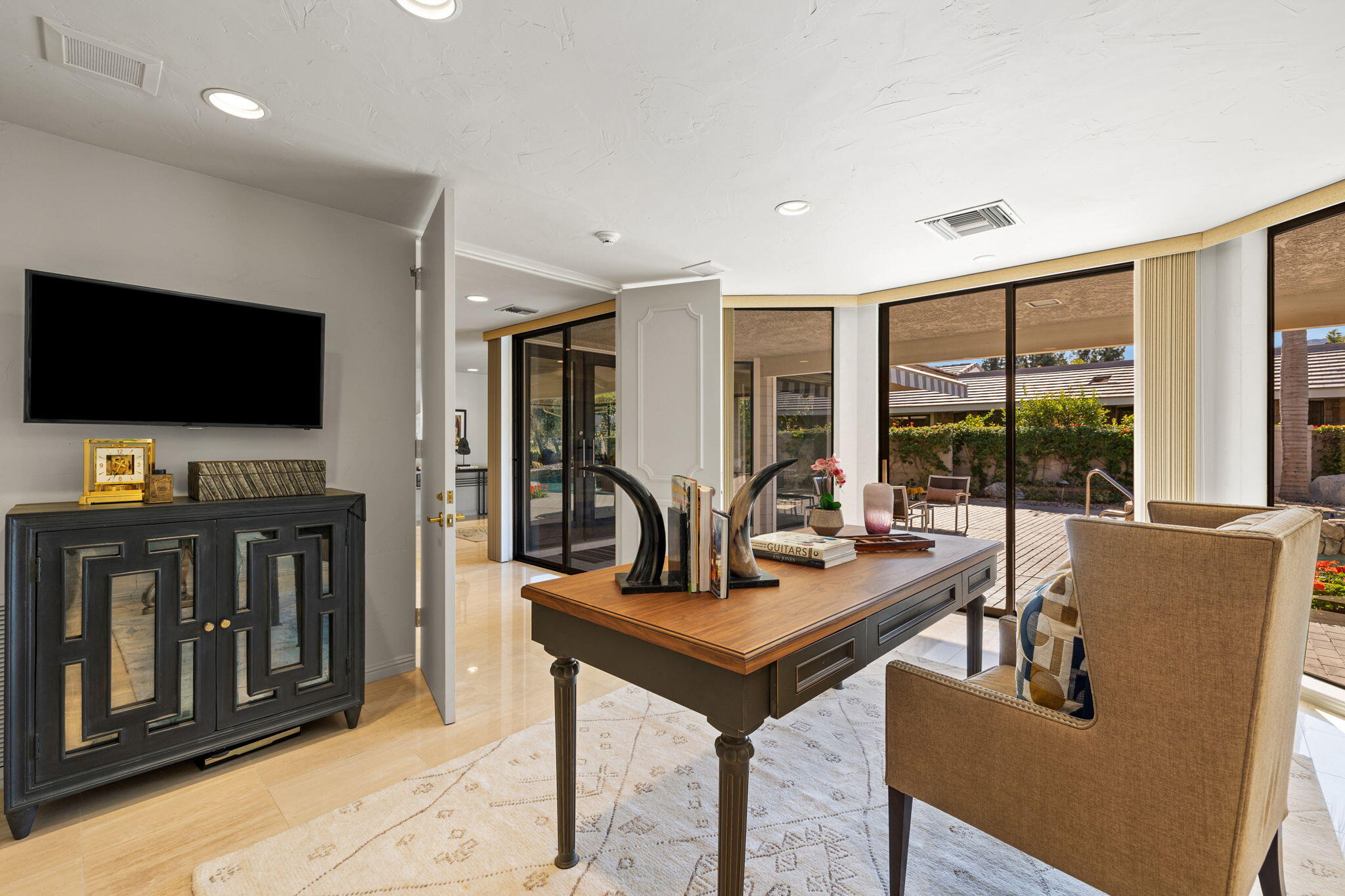 95 Mayfair Drive Rancho Mirage, CA 92270 - Photo 39 of 74 a living room with furniture and a flat screen tv