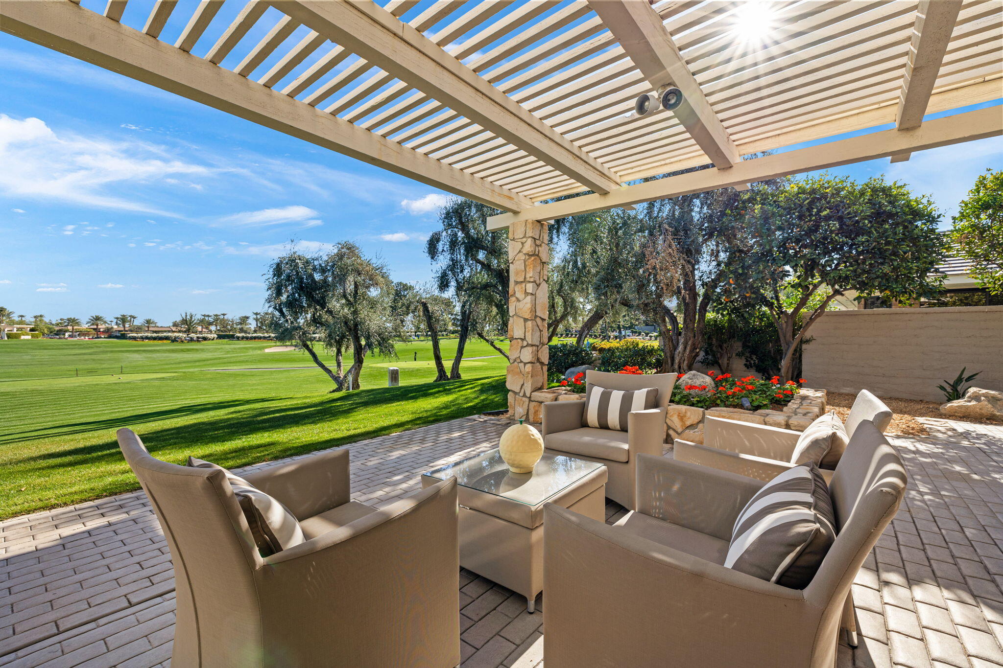 95 Mayfair Drive Rancho Mirage, CA 92270 - Photo 58 of 74 a view of a patio with couches chairs under an umbrella with a yard