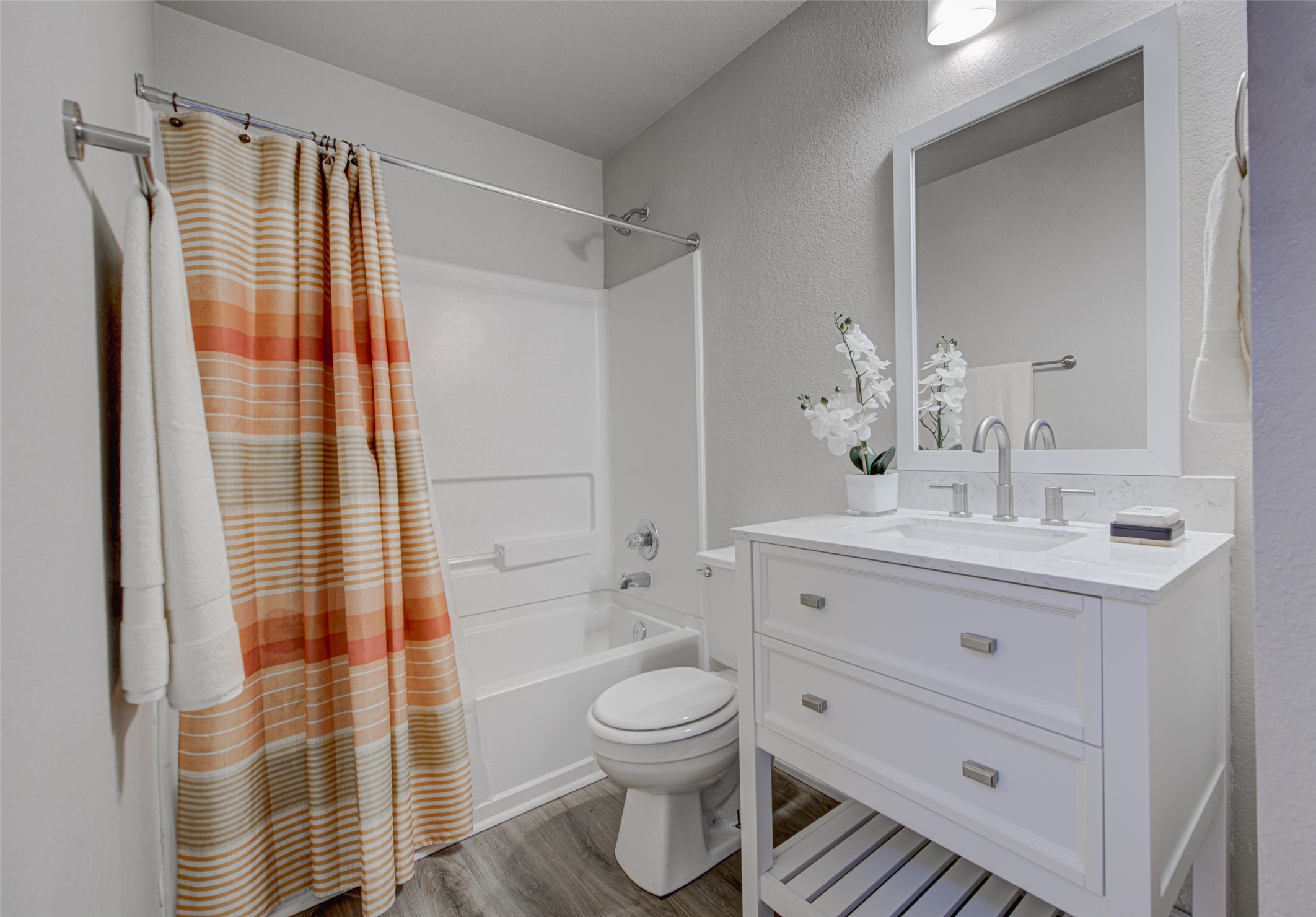 6709 Doyal Drive Austin, TX 78747 - Photo 15 of 22 Full bath featuring a textured wall, vanity, shower / bath combo with shower curtain, and light wood-style flooring
