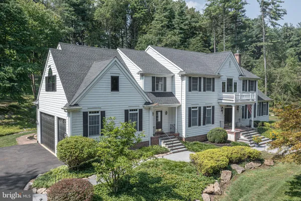 a aerial view of a house next to a yard