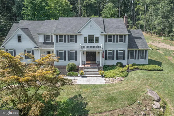 a front view of a house with garden and porch