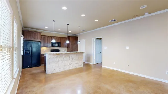 a view of kitchen with kitchen island a sink stainless steel appliances and cabinets