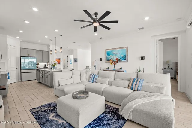 a living room with furniture and kitchen view