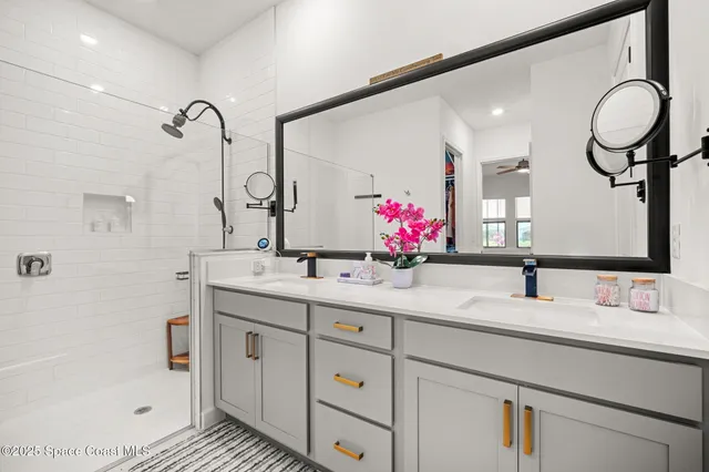 a bathroom with a sink double vanity and a mirror