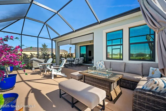a view of a patio with dining table and chairs under an umbrella