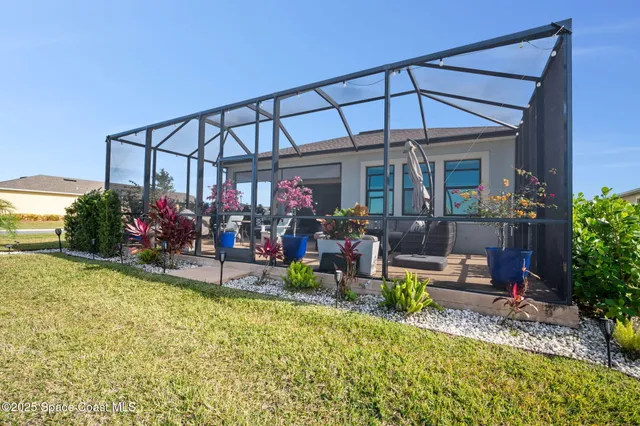an aerial view of a house with outdoor space