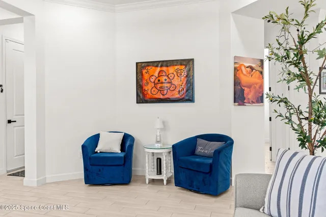 a living room with furniture and a potted plant