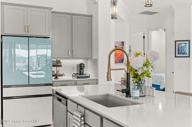 a kitchen with stainless steel appliances granite countertop a sink dishwasher and cabinets with wooden floor