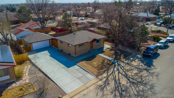 an aerial view of a house with a yard basket ball court and outdoor seating