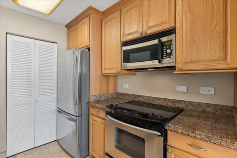 a kitchen with stainless steel appliances granite countertop a stove and a microwave