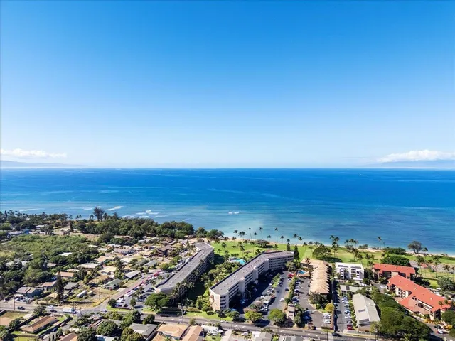 an aerial view of ocean and city