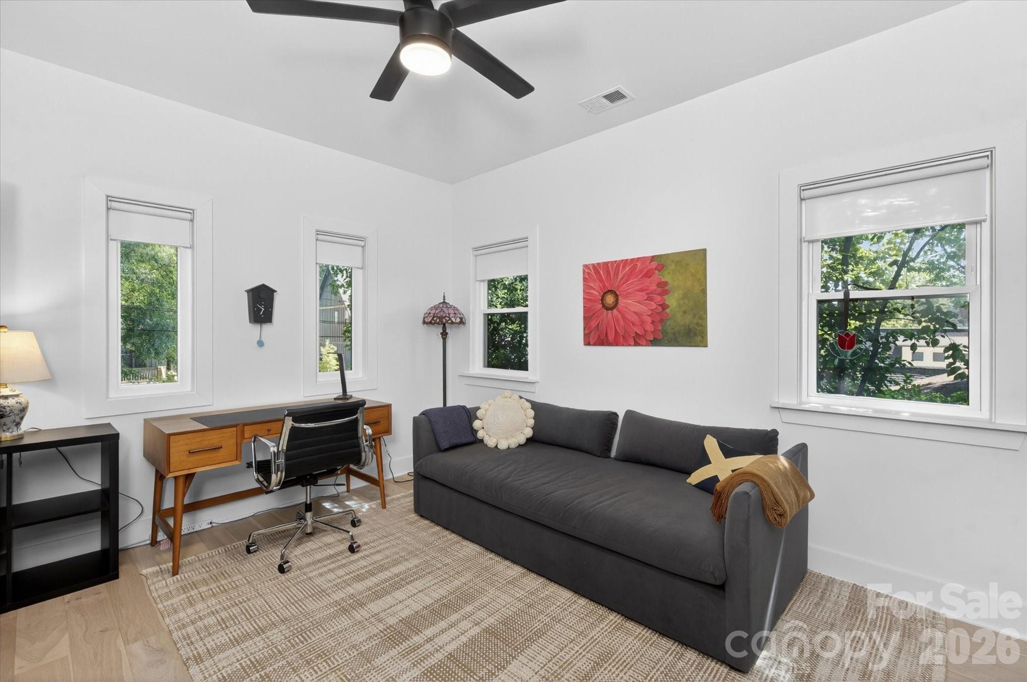 1608 Chippendale Road Charlotte, NC 28205 - Photo 42 of 46 a living room with furniture two window and a flat screen tv