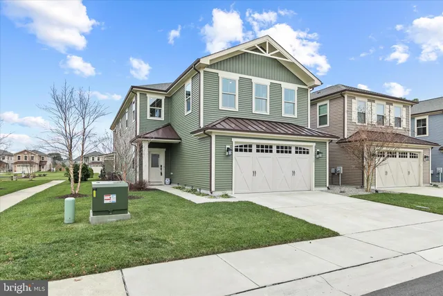 a front view of a house with a garden and yard
