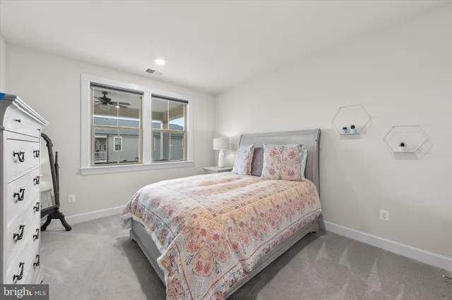 a dining room with furniture large windows and a chandelier