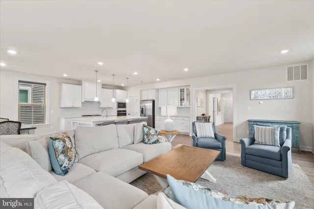 a kitchen with stainless steel appliances white cabinets and a refrigerator