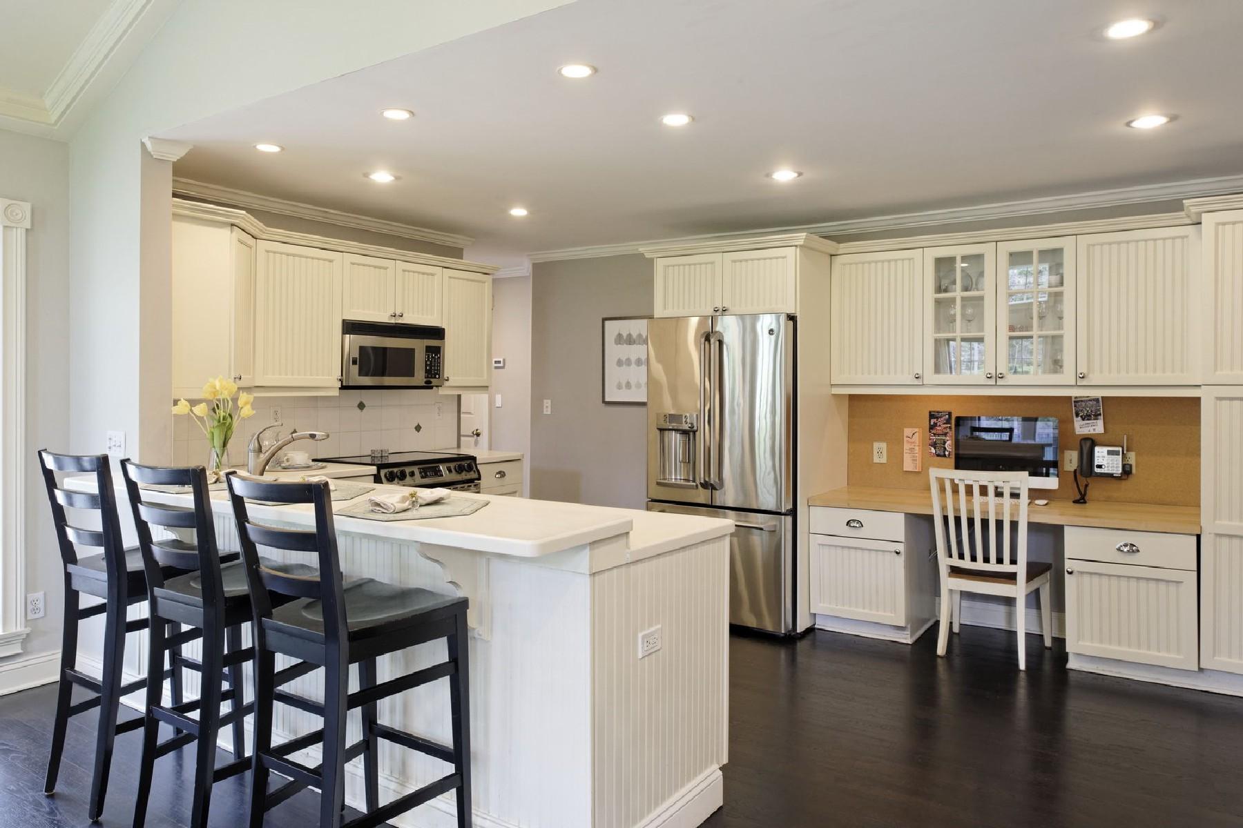 35 Hamilton Lane Darien, CT 06820 - Photo 7 of 25 a kitchen with stainless steel appliances a dining table chairs stove refrigerator and microwave